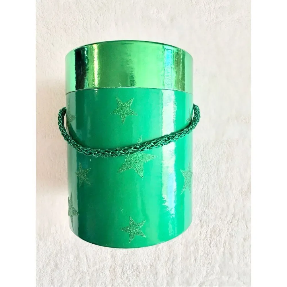 Bright Christmas green cylinder gift box with glitter stars